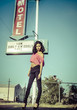 Photo: Motel sign with beautiful young woman Motel sign with beautiful young woman