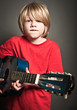 Cute boy learning an instrument