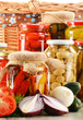 Foto: Composition with jars of pickled vegetables. Marinated food Composition with jars of pickled vegetables. Marinated food