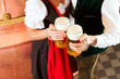 Man and woman with beer glass in brewery