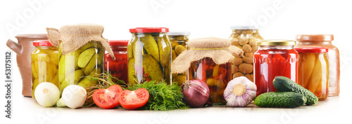 Photo: Composition with jars of pickled vegetables. Marinated food Composition with jars of pickled vegetables. Marinated food