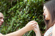 Photo: Man Gives His Wife a Flower Man Gives His Wife a Flower