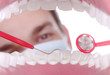 Caucasian Dentist Working Inside a Patient Mouth