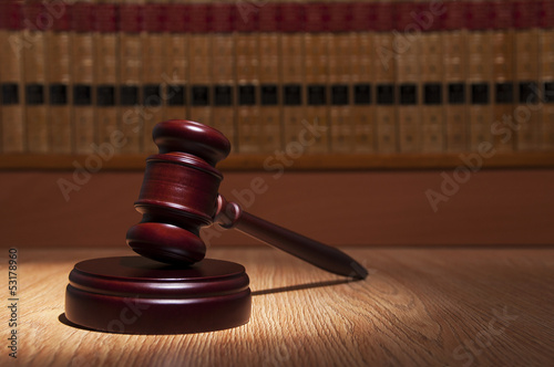 Photo: Judge gavel with books in the background Judge gavel with books in the background