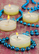 Lighted candles with beads close up