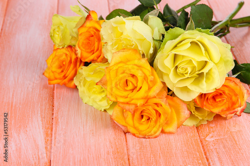 Photo: Beautiful bouquet of roses on table close-up Beautiful bouquet of roses on table close-up