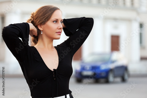 Photo: Beautiful woman daydreaming on the city street Beautiful woman daydreaming on the city street