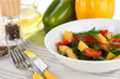 Photo: Light salad in plate on wooden table Light salad in plate on wooden table