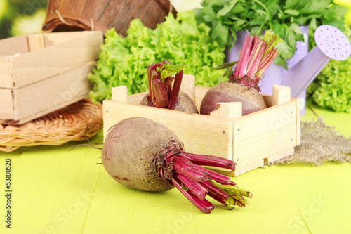 Photo: Young beets on wooden box on wooden table close-up Young beets on wooden box on wooden table close-up