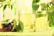 Glasses of birch sap on green wooden table