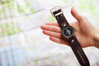 Closeup image of hand with magnetic compass over a map