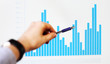 Image of hand pointing on a graph data
