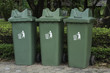 Green plastic recycle bin in park