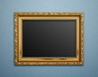 Empty golden vintage frame on wallpaper background