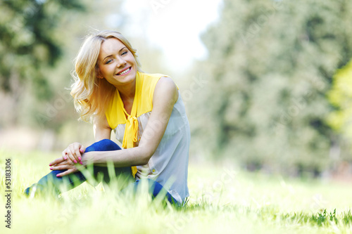 Photo: Woman sitting on grass Woman sitting on grass