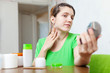  woman stares on her neck
