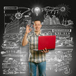 Photo: Idea Concept asian male with laptop in his hands shows OK Idea Concept asian male with laptop in his hands shows OK