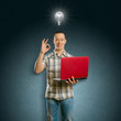 Photo: Idea Concept asian male with laptop in his hands shows OK Idea Concept asian male with laptop in his hands shows OK
