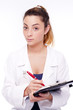 Young female doctor holding notepad isolated on white
