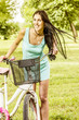 cheerful young woman with bicycle