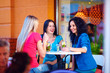 three beautiful girls sitting on cafe terrace