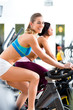 Photo: People Spinning in the gym on bicycles People Spinning in the gym on bicycles