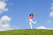 pretty young woman jumping on green grass