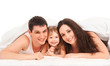 Happy family, mother, father and daughter resting on the white b