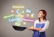 Young woman cooking vitamins and minerals