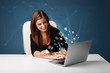 Young lady sitting at dest and typing on laptop with message ico