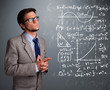 Photo: Handsome school boy thinking about complex mathematical signs Handsome school boy thinking about complex mathematical signs