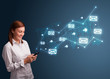 Photo: Young lady holding a phone with arrows and message icons Young lady holding a phone with arrows and message icons