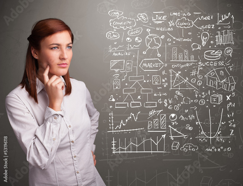 Photo: Pretty woman looking at stock market graphs and symbols Pretty woman looking at stock market graphs and symbols