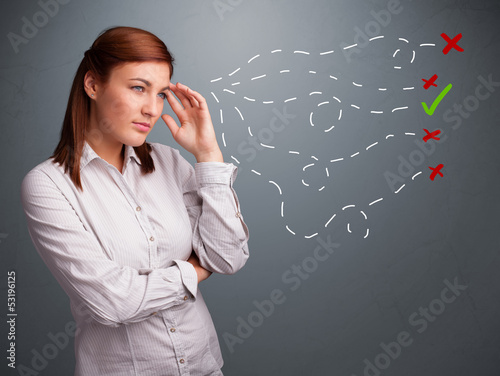 Photo: Young woman choosing between right and wrong signs Young woman choosing between right and wrong signs