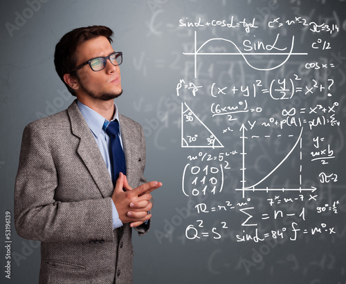 Photo: Handsome school boy thinking about complex mathematical signs Handsome school boy thinking about complex mathematical signs