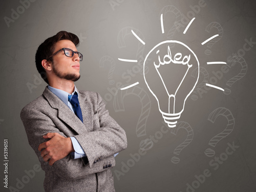 Photo: Young boy comming up with a light bulb idea sign Young boy comming up with a light bulb idea sign