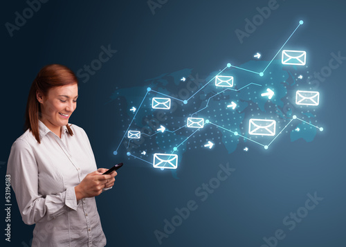Photo: Young lady holding a phone with arrows and message icons Young lady holding a phone with arrows and message icons