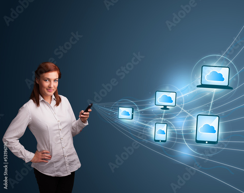 Photo: Pretty lady typing on smartphone with cloud computing Pretty lady typing on smartphone with cloud computing