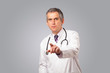 Photo: Middle aged doctor gesturing with copy space Middle aged doctor gesturing with copy space