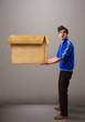 Goog-looking man holding an empty brown cardboard box