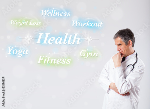 Photo: Clinical doctor pointing to health and fitness collection of wor Clinical doctor pointing to health and fitness collection of wor