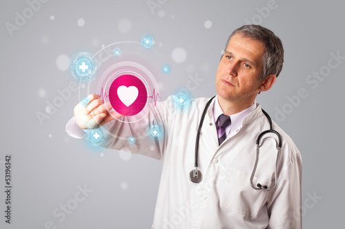 Photo: Middle aged doctor pressing modern medical type of button Middle aged doctor pressing modern medical type of button