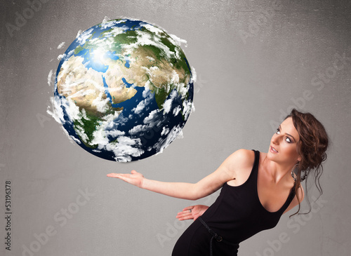 Photo: Pretty girl holding 3d planet earth Pretty girl holding 3d planet earth