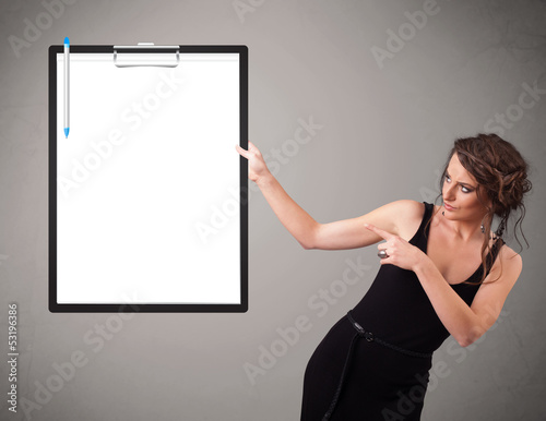 Photo: Young girl holding black folder with white sheet copy space Young girl holding black folder with white sheet copy space