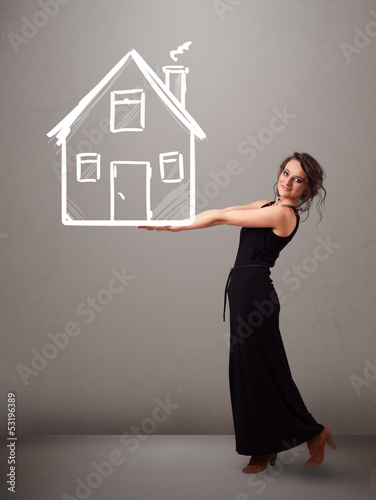 Photo: Young lady holding a huge drawn house Young lady holding a huge drawn house