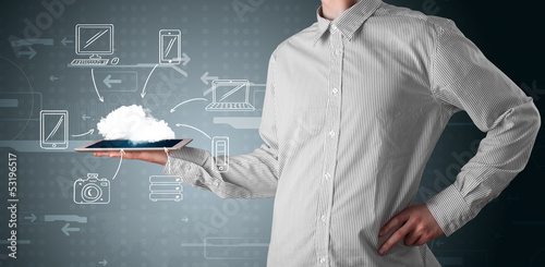 Photo: Businessman showing hand drawn cloud computing Businessman showing hand drawn cloud computing