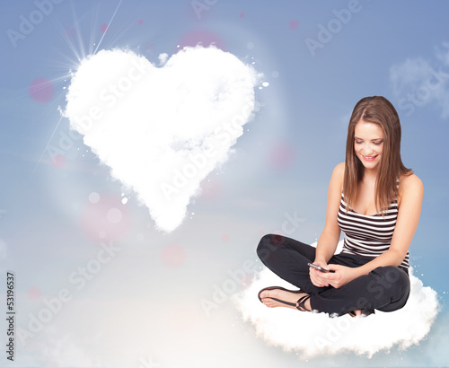 Photo: Beautiful lovely woman sitting on cloud with heart Beautiful lovely woman sitting on cloud with heart