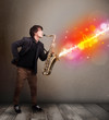 Young man playing on saxophone with colorful sound waves