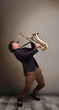 Young musician playing on saxophone