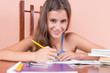 Hispanic girl studying at home and smiling